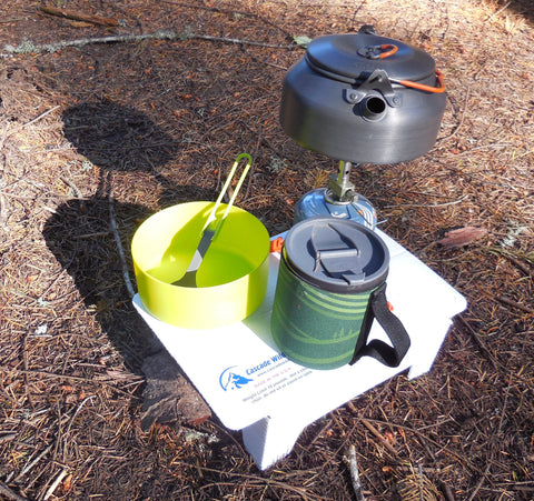A kettle and a pot on a stove
Description automatically generated